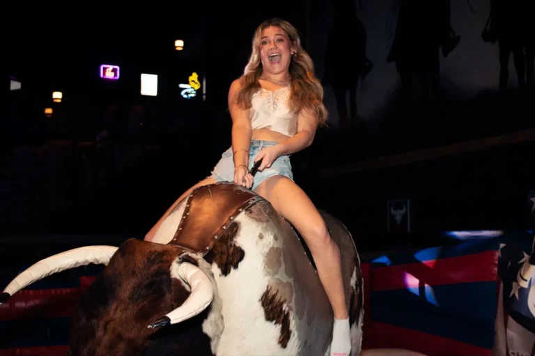 Feel the excitement in the air as friends take on the challenge of the mechanical bull at Stampede Houston! #HoustonNightlife #NightclubFun #StampedeHouston